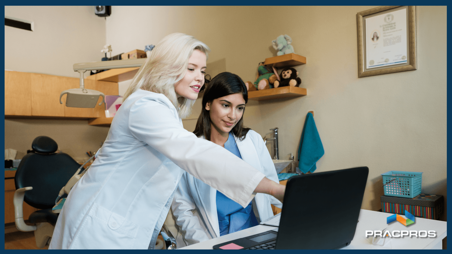 Two dentists discussing information on a laptop