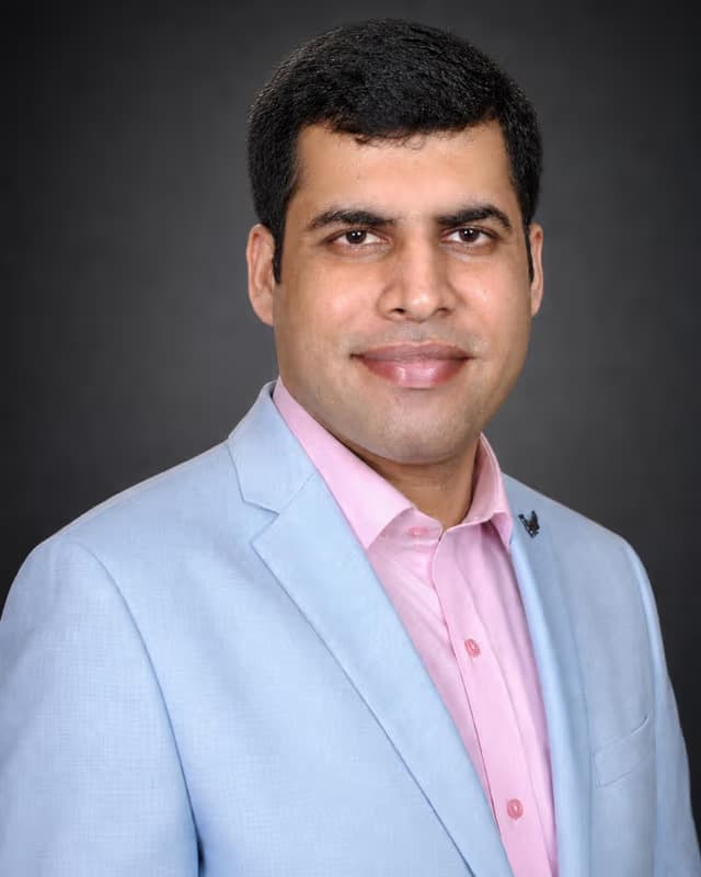 Dr. Harit Talwar of West 17th Avenue Dental Care in a light blue blazer
