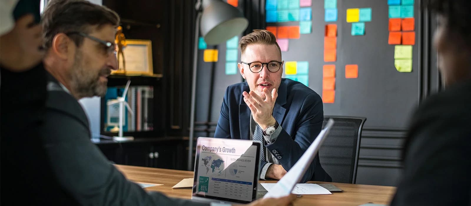 Marketing consultant presenting to a client across a meeting table