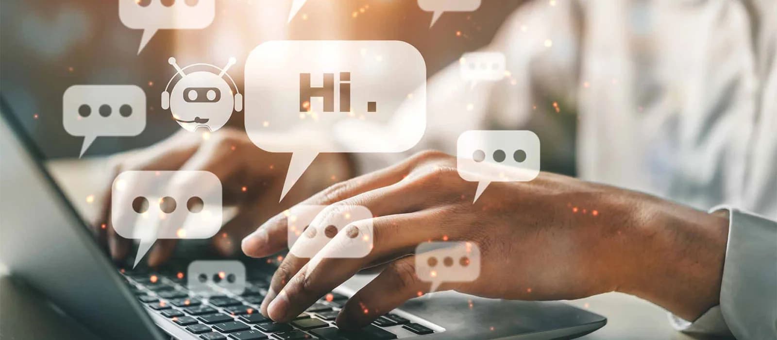 Hands typing on a laptop surrounded by chat bubble icons